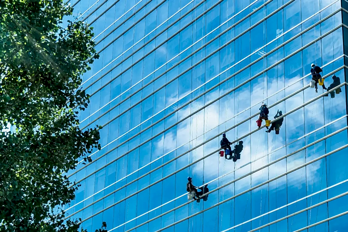 Servicio profesional de limpieza de vidrios en altura con cuerdas para edificios en Chile.